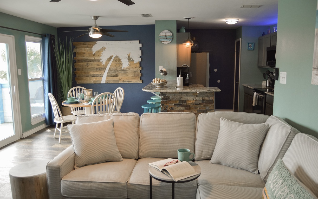 Sink into comfort in your open-concept living space, where coastal charm meets modern convenience with a sleeper sofa.