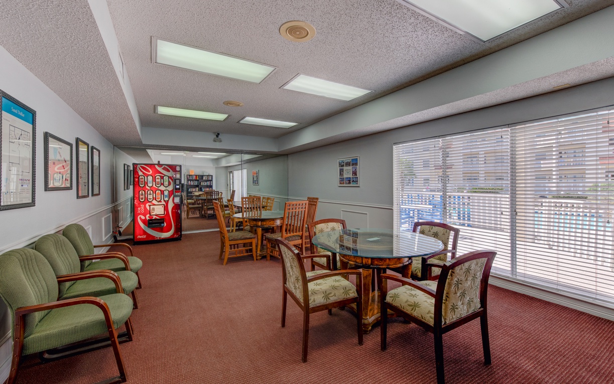 Relax in this comfortable communal space with cozy seating, dining tables, and a vending machine for snacks.