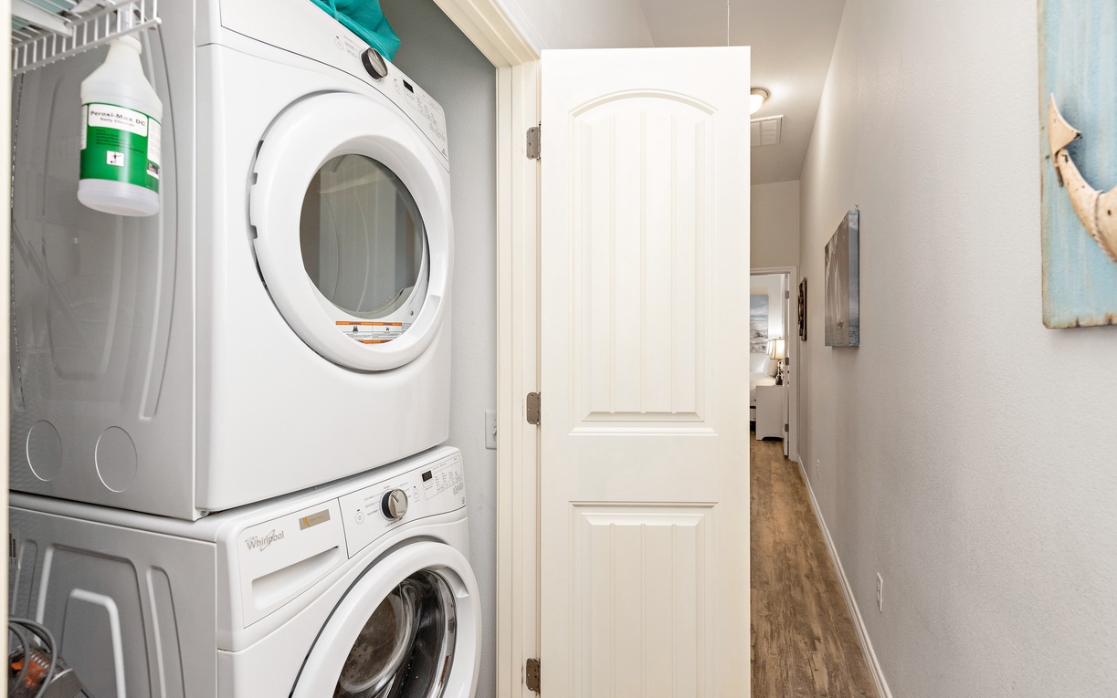Your private laundry nook keeps your vacation wardrobe fresh and convenient, tucked neatly into this bright hallway space.