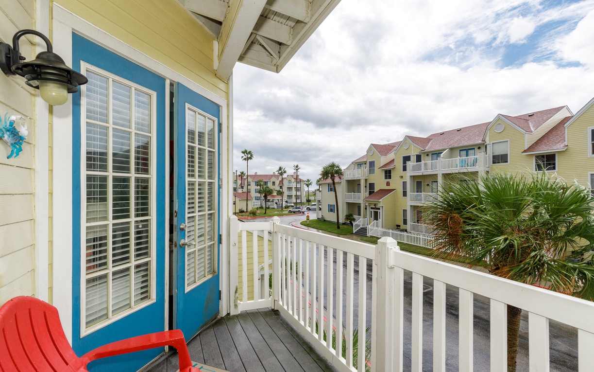 Your private balcony offers a peaceful spot to unwind with colorful coastal charm and tropical neighborhood views.