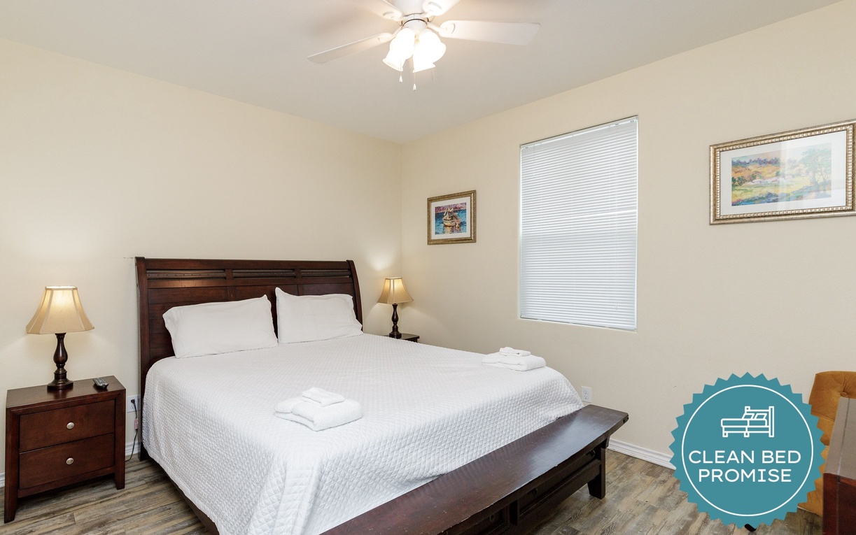 Drift into peaceful sleep in your serene bedroom featuring soft linens and gentle ceiling fan breezes.