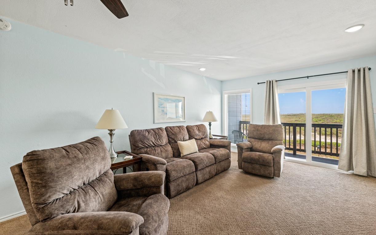 Sink into plush seating and let the natural light wash over you as you take in sweeping views through your private balcony doors—a perfect spot to unwind after a day of adventure.