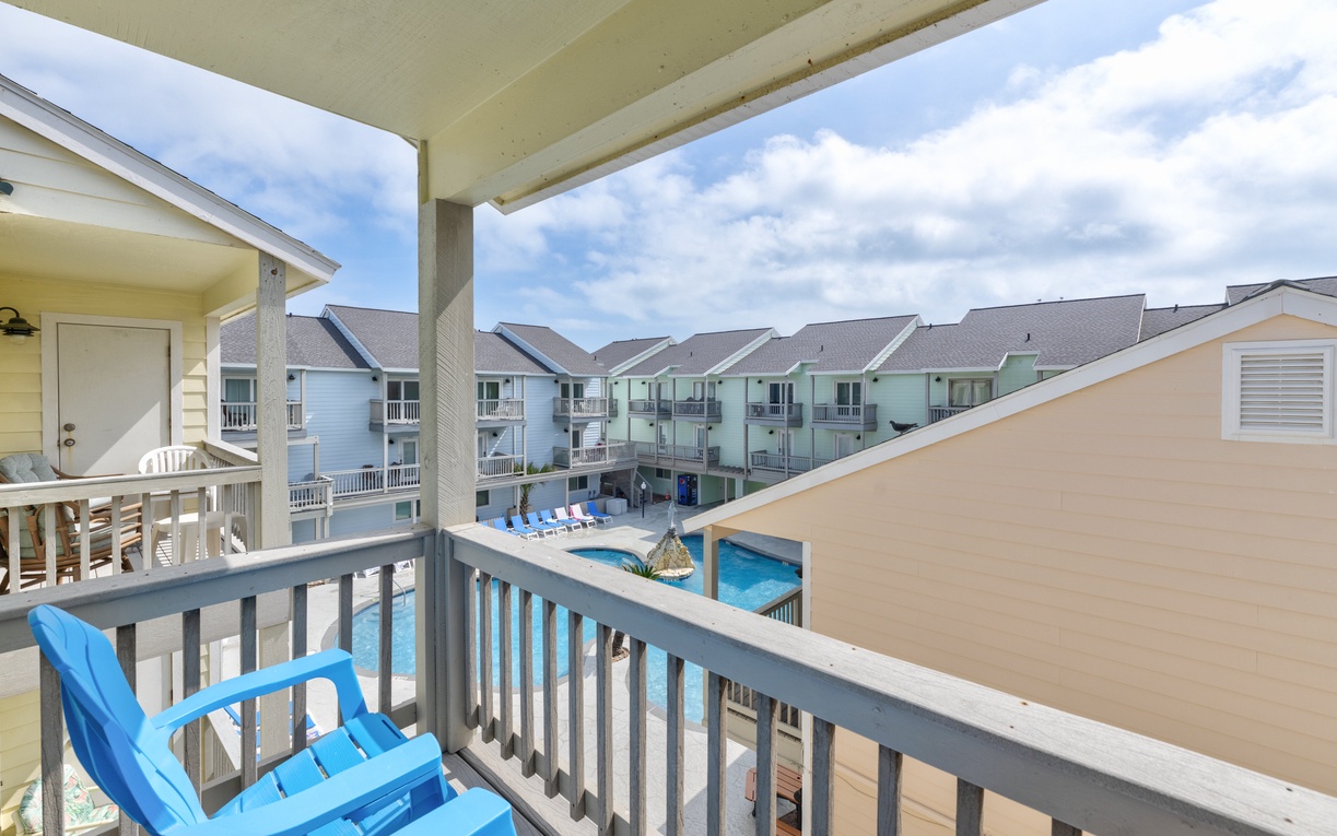 Your primary bedroom balcony offers comfortable seating with pool views, perfect for morning coffee or evening relaxation.
