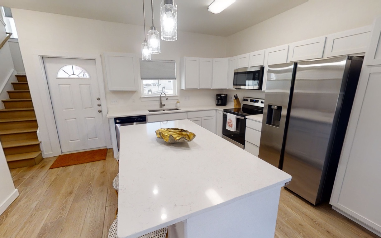 Your fully equipped kitchen features gleaming quartz countertops, stainless steel appliances, and elegant pendant lighting for memorable meal preparation.