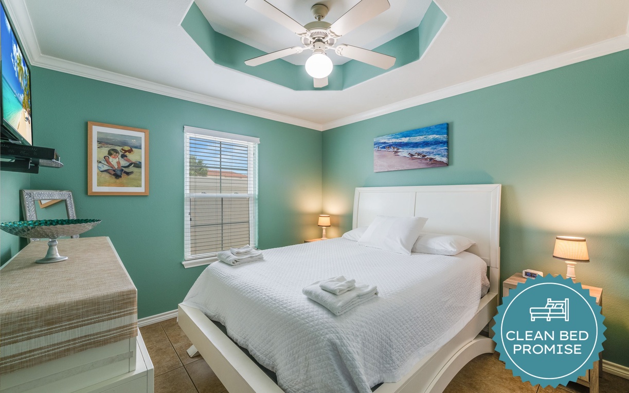 Drift into peaceful dreams in your coastal-themed bedroom, where turquoise walls and ocean artwork create a serene seaside escape.