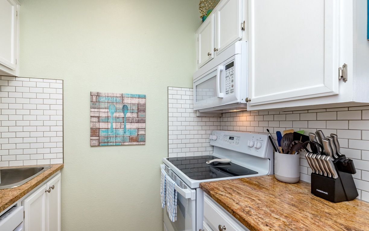 Your fully equipped kitchen features granite countertops, subway tile backsplash, and everything you need to prepare your favorite meals during your stay.