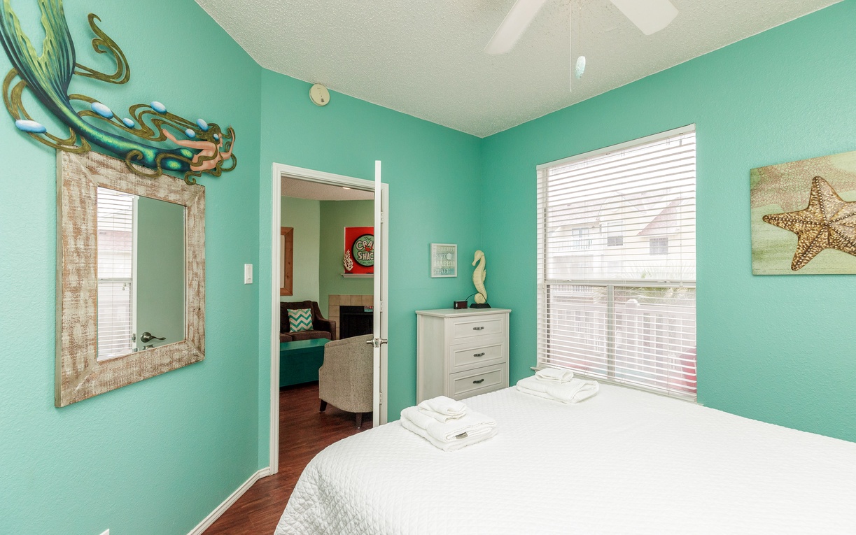 Rest in your ocean-themed retreat with a queen size bed.
