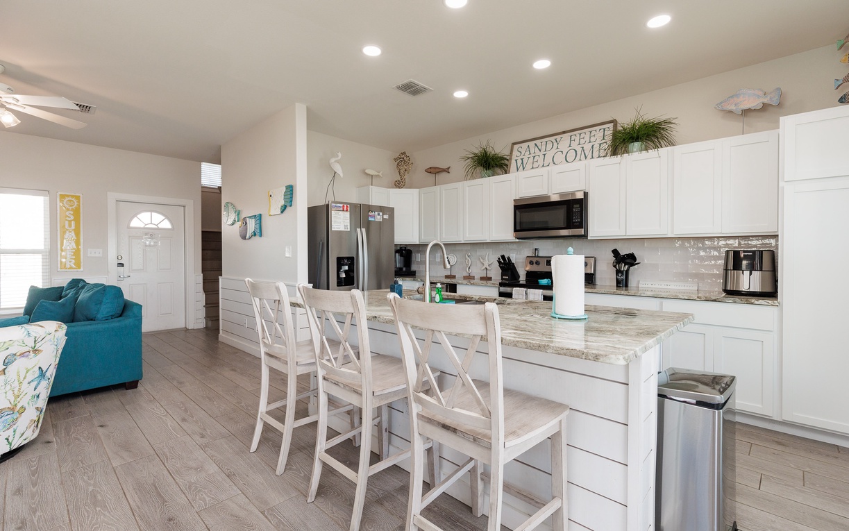 Your bright, open kitchen features granite counters and stainless appliances, perfect for preparing meals while chatting with family at the breakfast bar.