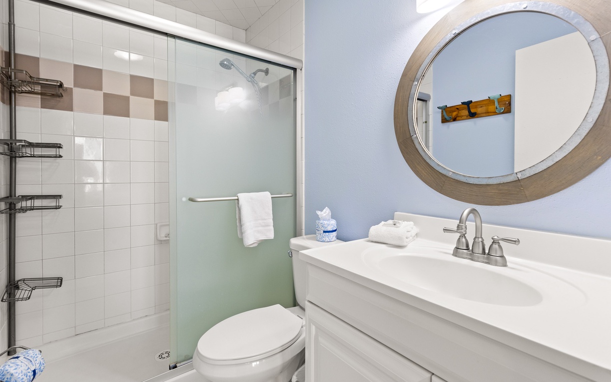 Your private bathroom features a walk-in shower, stylish vanity, and fresh towels for your comfort.