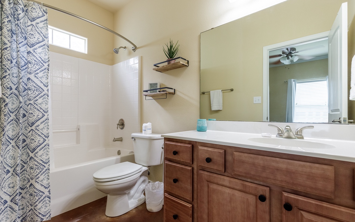 Your private bathroom features a relaxing tub-shower combo with stylish tilework and ample counter space for all your essentials.