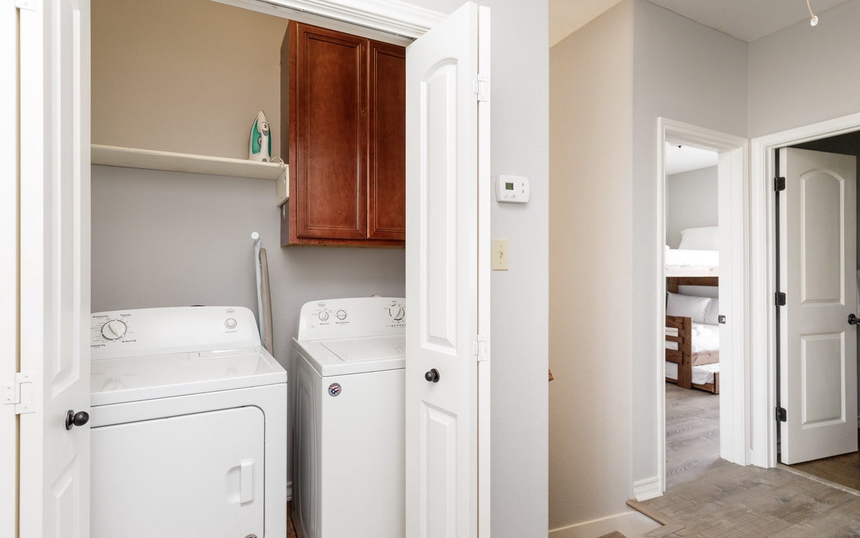 Your dedicated laundry space features full-size washer and dryer with convenient storage above, making longer stays effortless and comfortable.