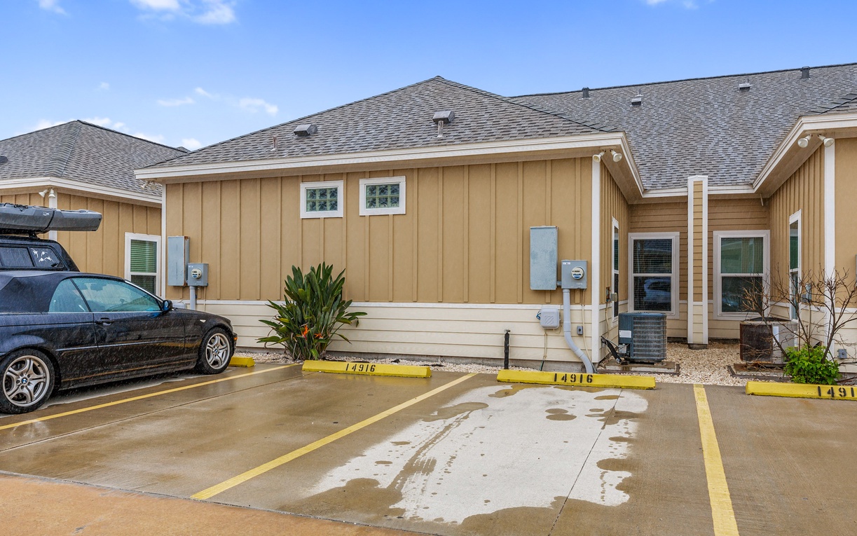 Modern vacation rental complex with convenient numbered parking spaces right outside your door for easy arrival and departure.