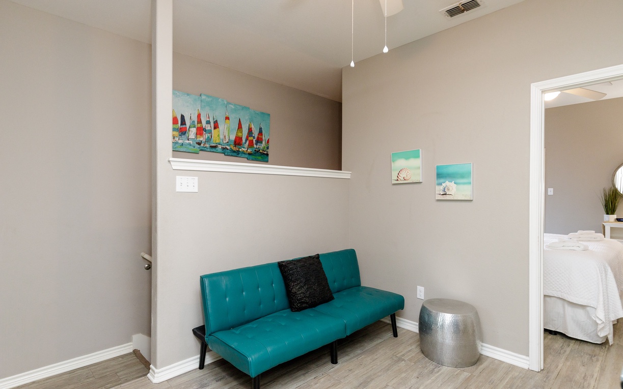 Unwind in your stylish living space with nautical artwork and comfortable seating for peaceful moments.