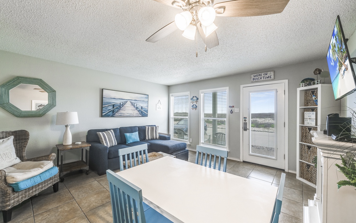 Your coastal retreat awaits with ocean-themed décor, comfortable seating, and French doors opening to stunning water views.
