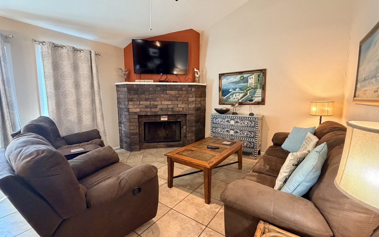 Sink into plush recliners by your cozy brick fireplace, where warm evenings begin with your favorite shows on the wall-mounted TV.