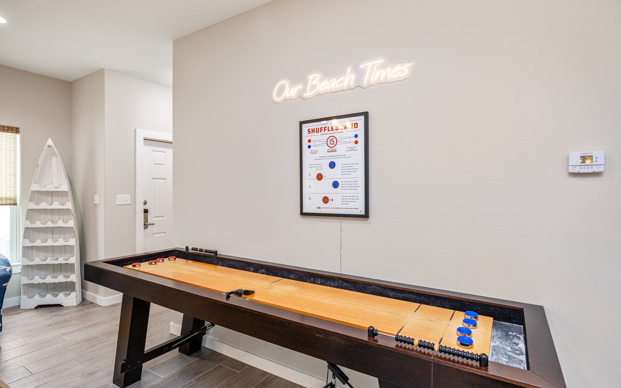 Challenge friends to a game of shuffleboard in your private game room, complete with neon accent lighting and coastal vibes.