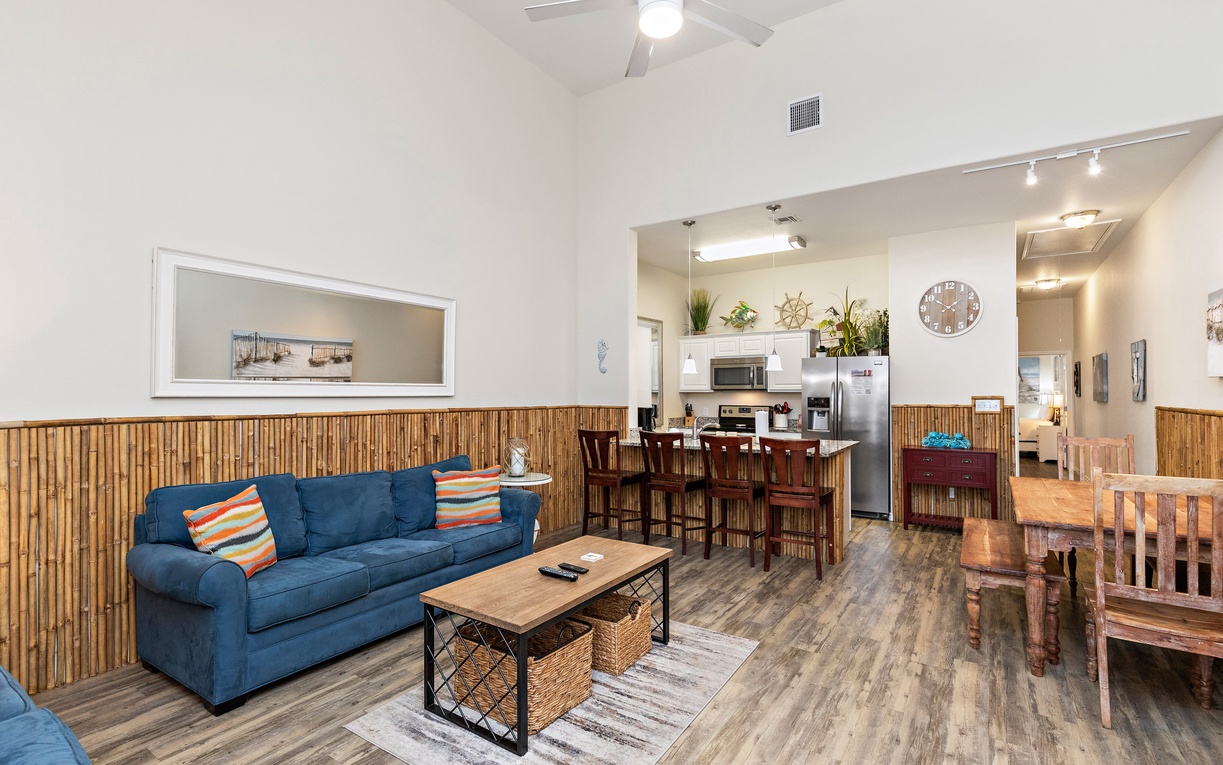 Relax in your stylish open-concept space where bamboo accents meet modern comfort, complete with a fully equipped kitchen and cozy living area.