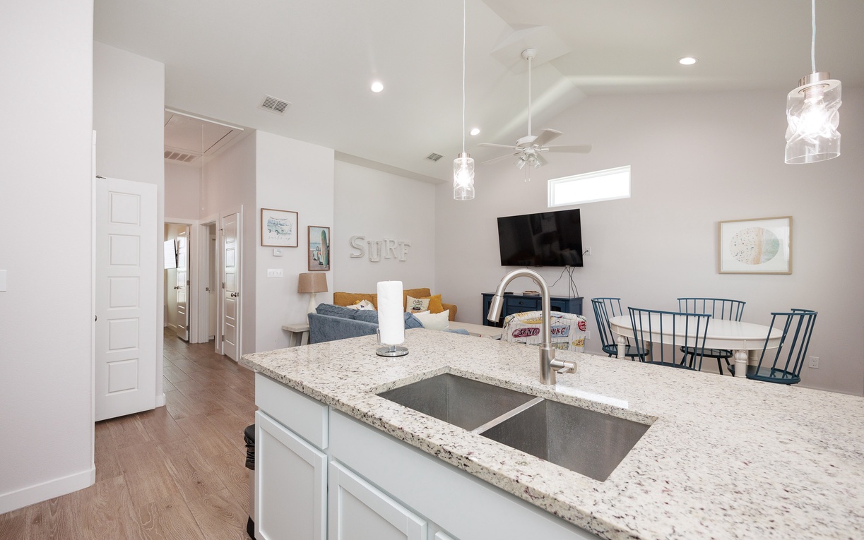 Step into your spacious open-concept living area where modern comfort meets coastal charm, perfect for gathering with loved ones.