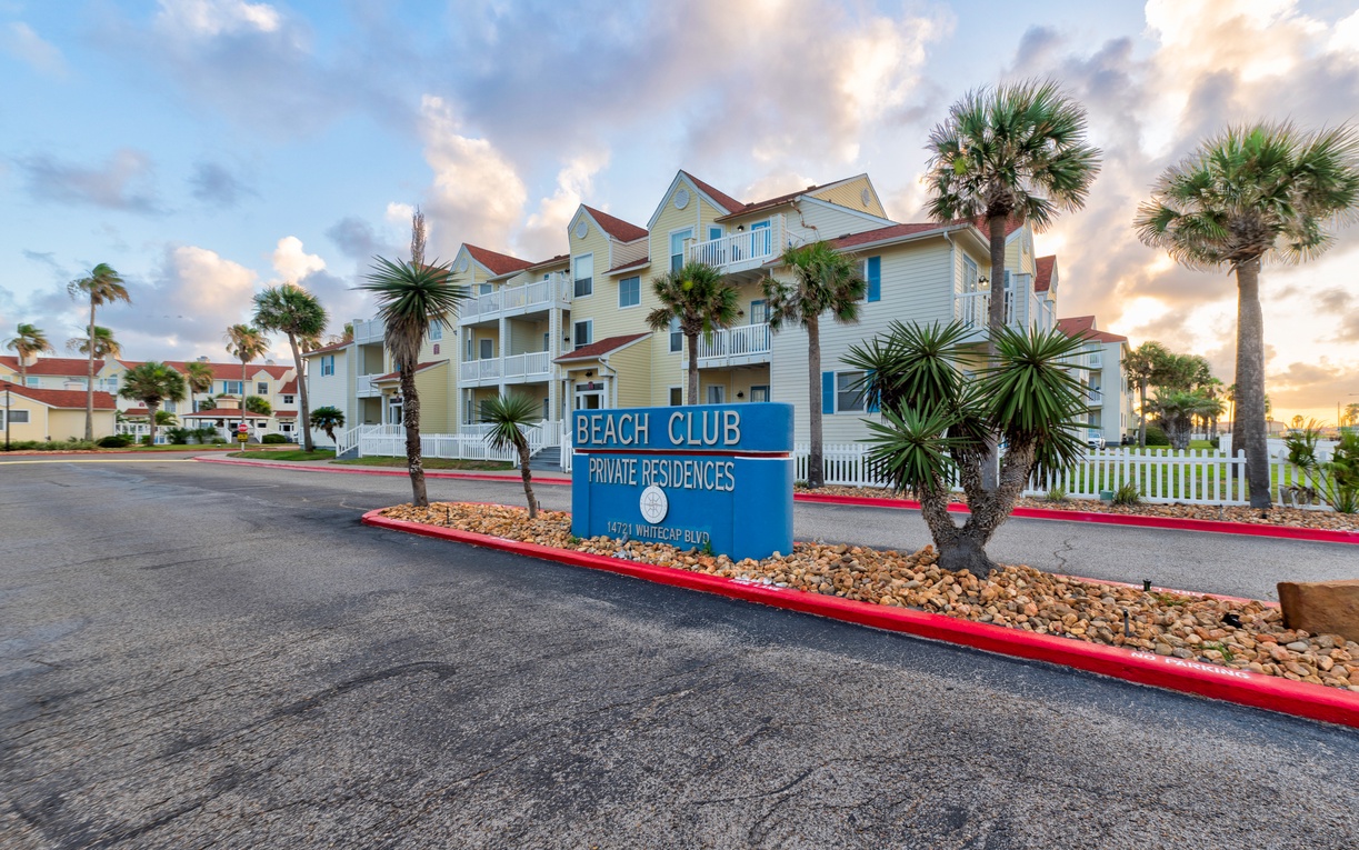 Beach Club Private Residences welcomes guests with coastal charm and tropical landscaping at this beachside retreat.