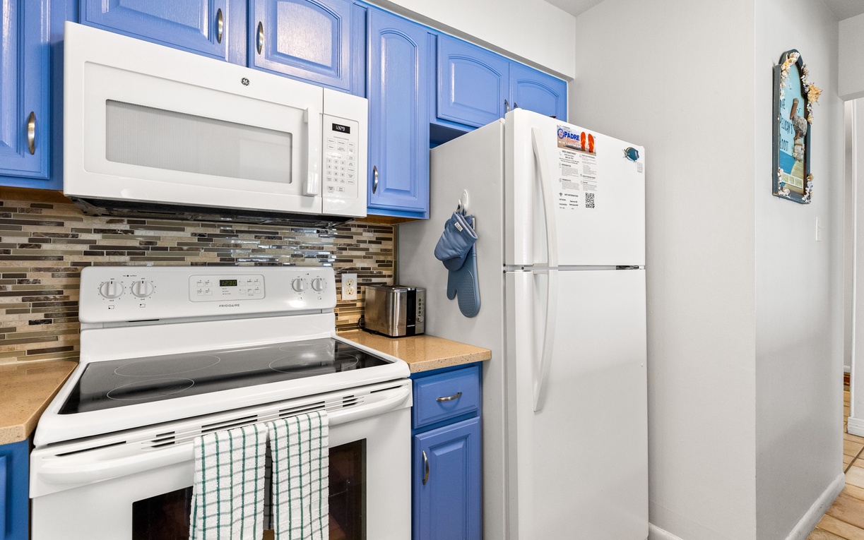 Your fully equipped kitchen features bright blue cabinets, modern appliances, and everything you need to prepare meals during your stay.