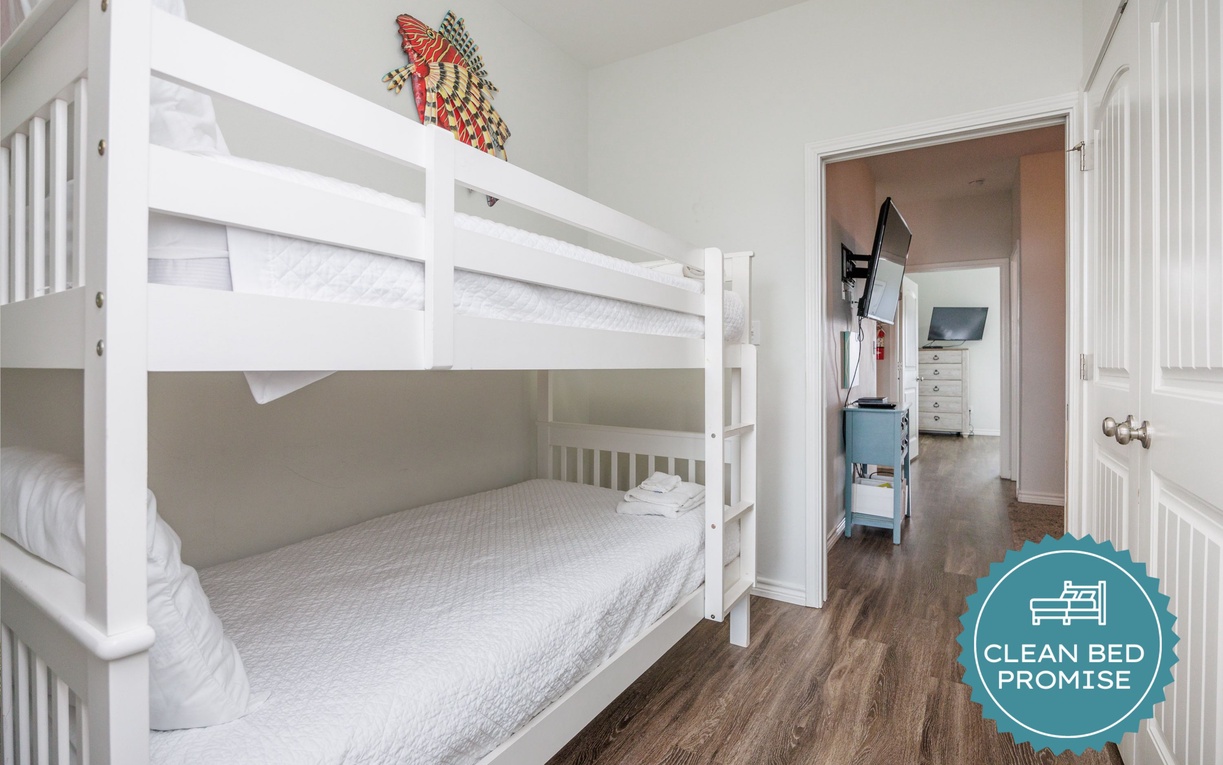 Cozy bunk beds create the perfect adventure basecamp for your little explorers, with comfortable sleeping spaces in a bright, cheerful room.