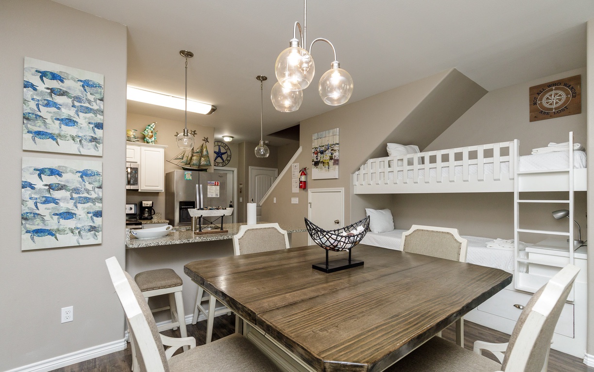 Your spacious dining area flows seamlessly into the kitchen, with charming nautical touches and bunk beds perfect for family gatherings.