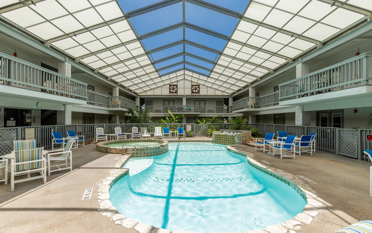 Enjoy year-round swimming in this stunning glass-covered atrium pool where natural light floods through while you relax poolside.