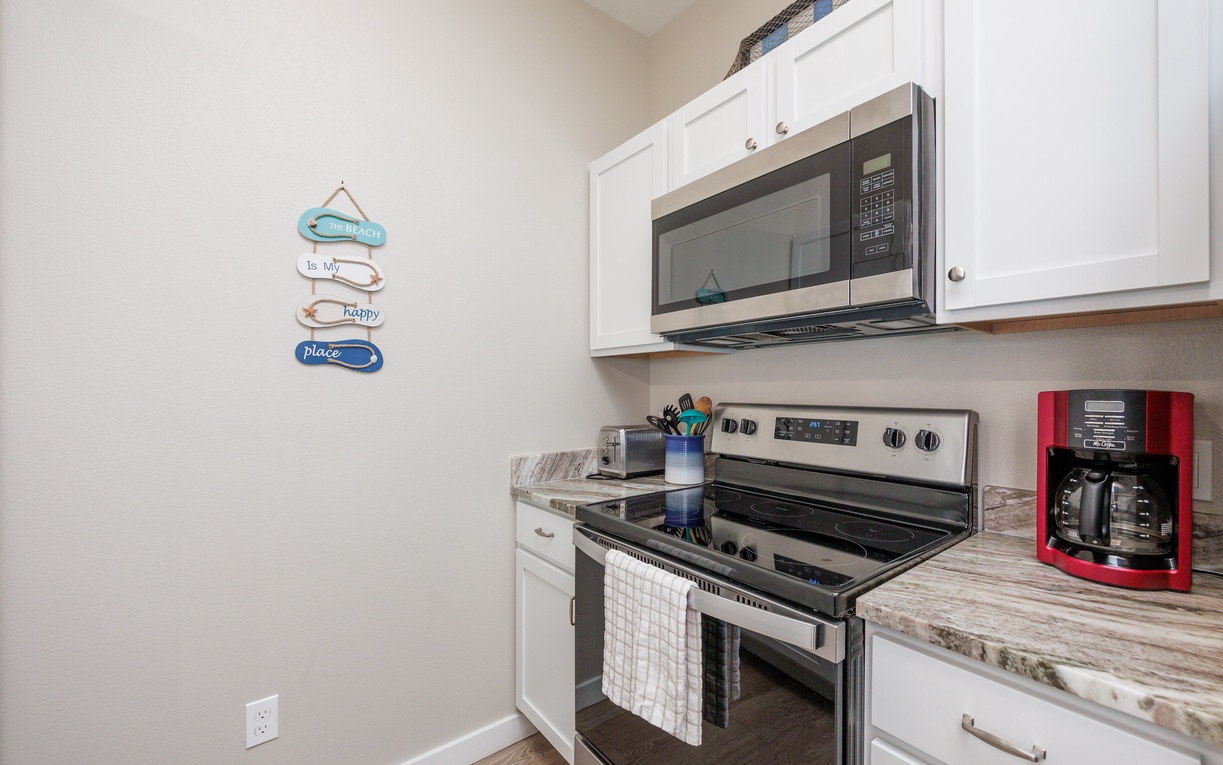 Your fully equipped kitchen features modern appliances and beachy décor, making meal prep a joy during your coastal getaway.