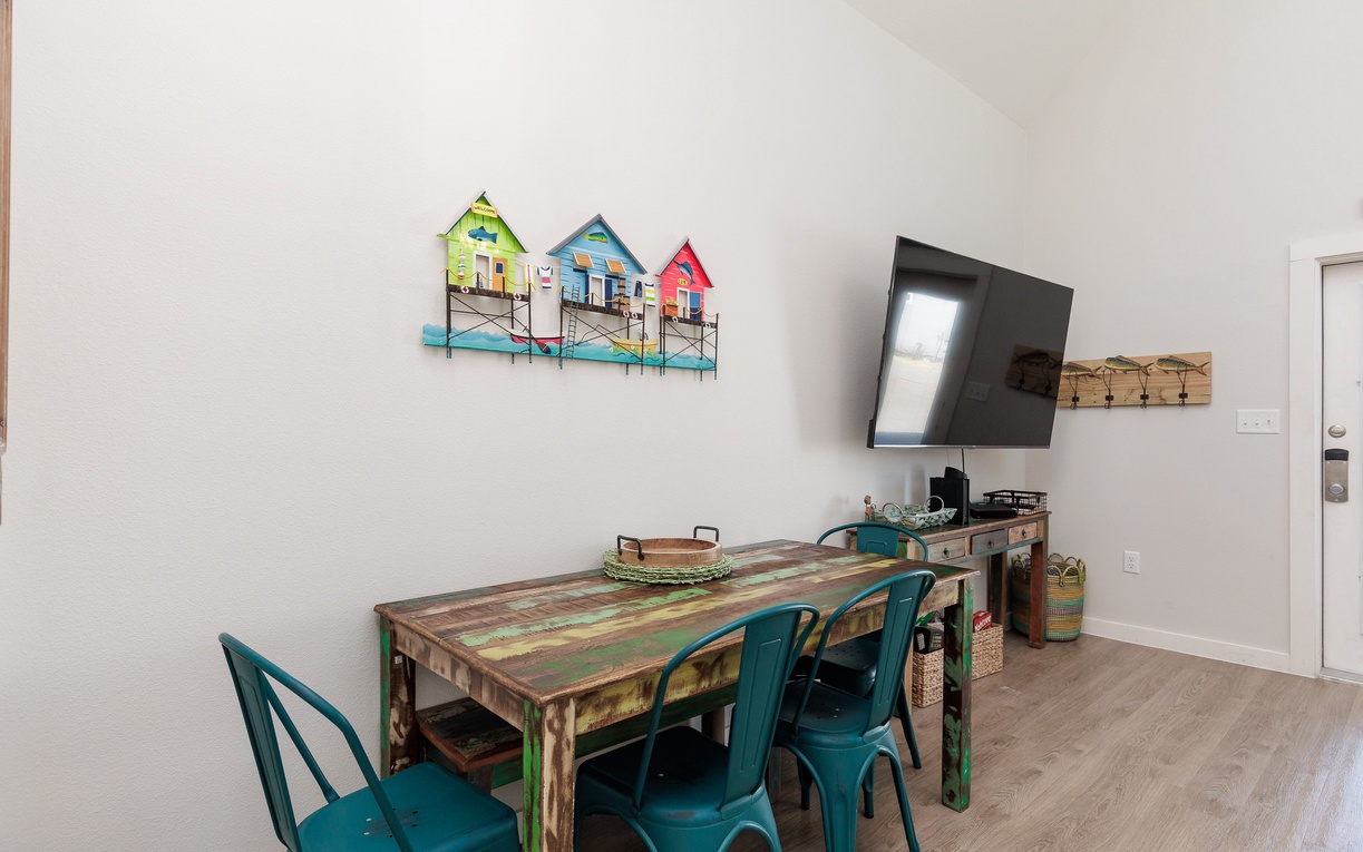 Gather around your stylish dining table with coastal artwork creating the perfect backdrop for memorable meals and game nights together.