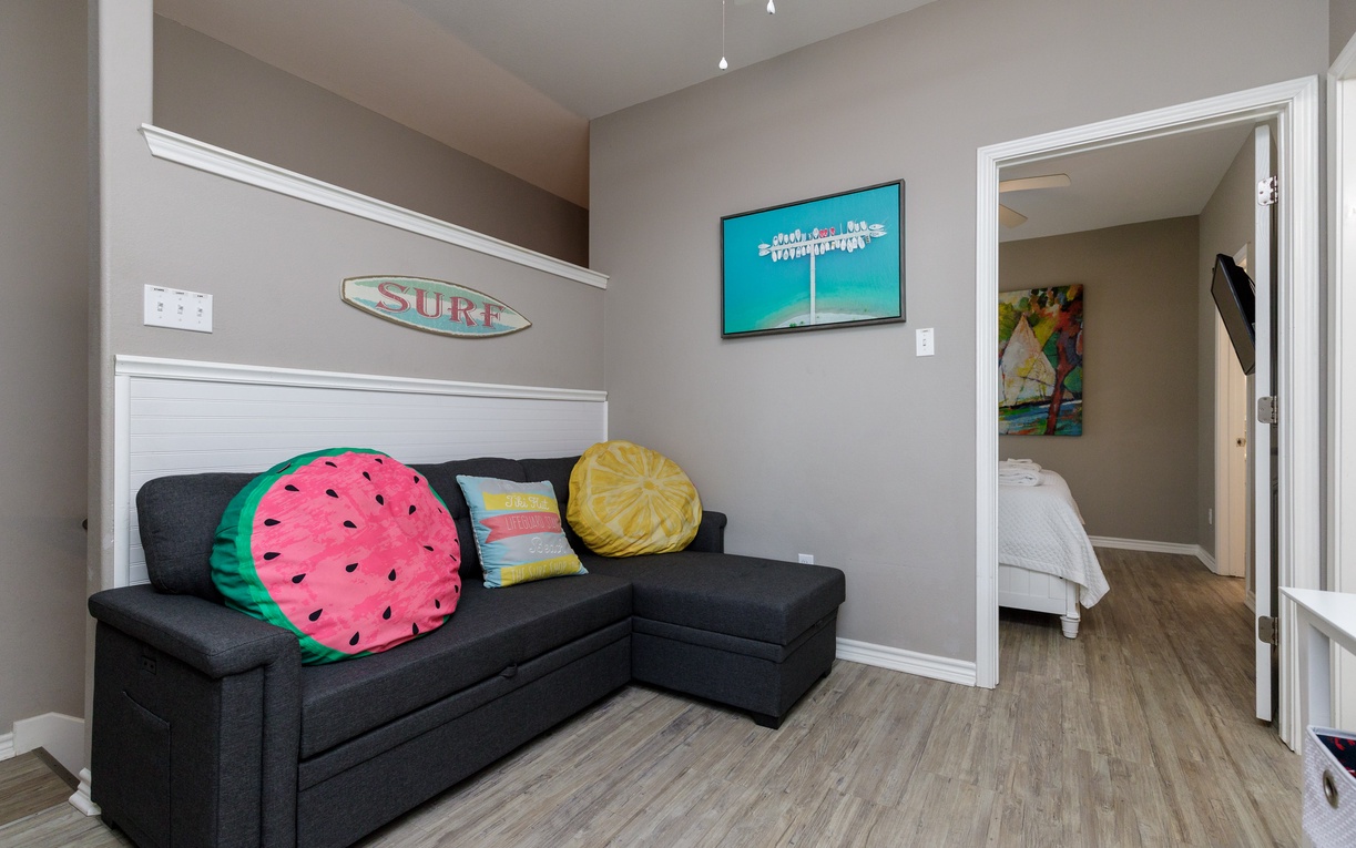 Relax on this cozy sectional after beach adventures. Playful watermelon pillows and surf-inspired décor create a fun, coastal vibe perfect for unwinding.