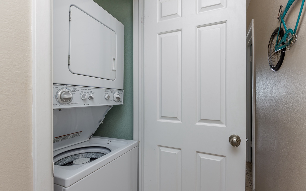 Keep your clothes fresh during your stay with convenient in-unit laundry facilities, tucked away behind a closet door.