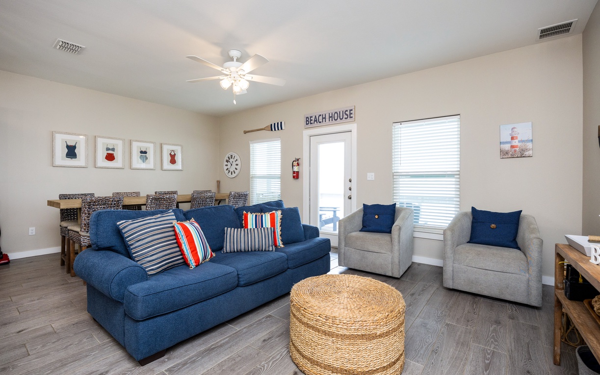 Sink into coastal comfort in your bright living room, where nautical touches and plush seating create the perfect space to unwind after beach adventures.