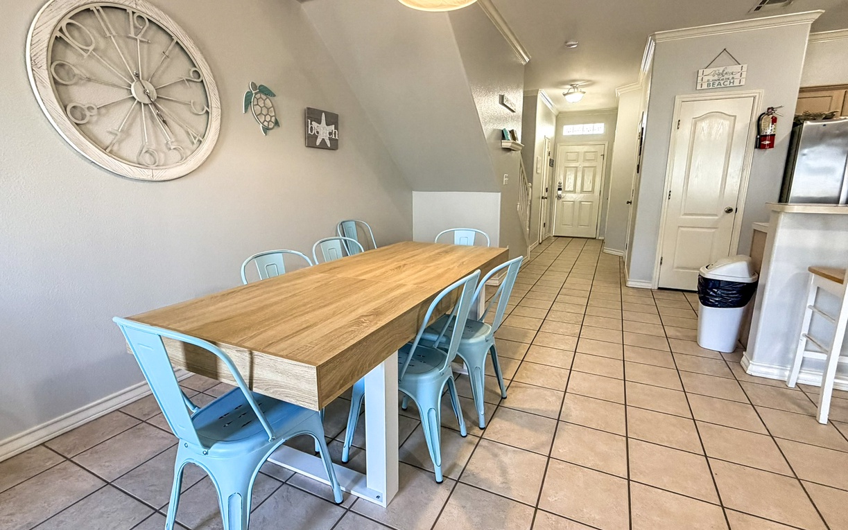 Gather around the dining table in your open-plan living area, comfortably seating eight, where coastal décor sets the perfect beachside ambiance.