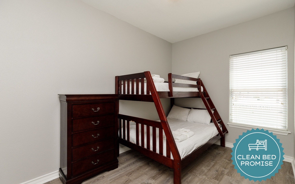 Sleep soundly in your cozy bunk bed retreat, featuring rich wood finishes and bright natural light.