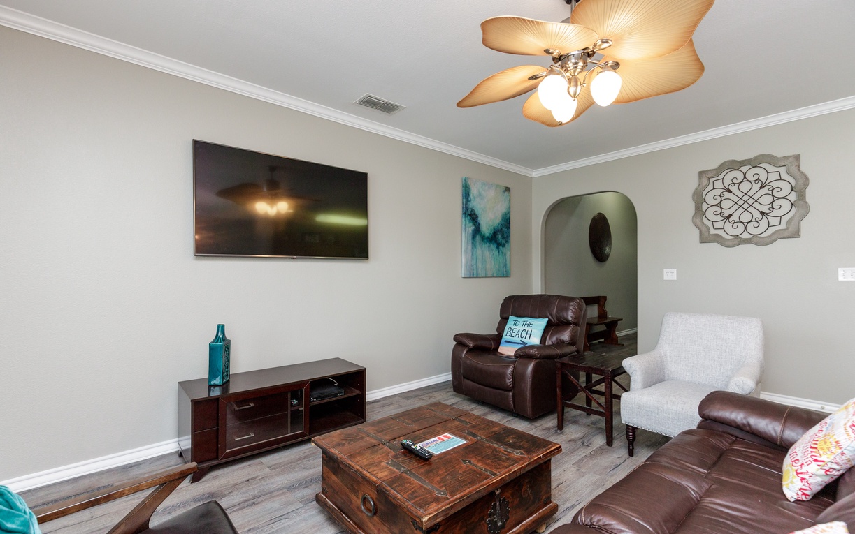 Sink into plush leather seating in your cozy living room, where warm lighting and thoughtful décor create the perfect atmosphere for relaxing evenings.