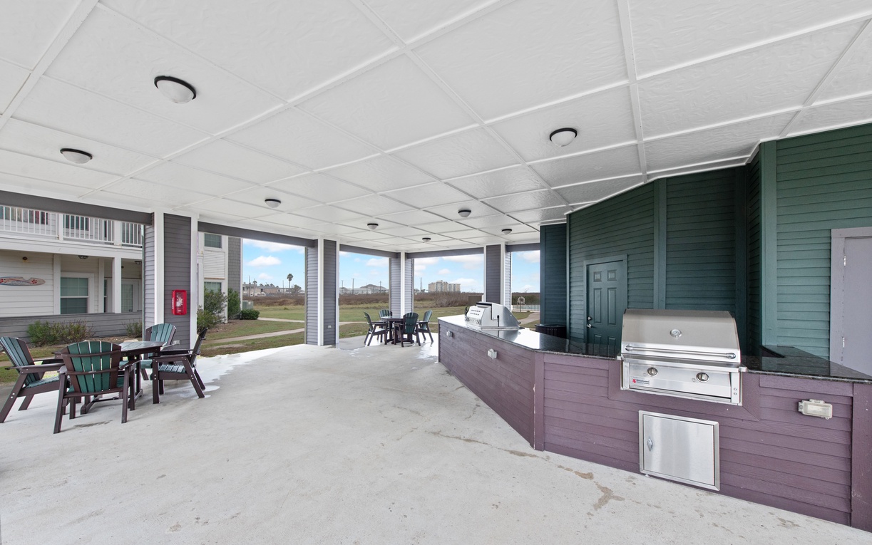 Your covered outdoor entertaining space features a built-in grill and dining area, perfect for beachside cookouts with ocean breezes.