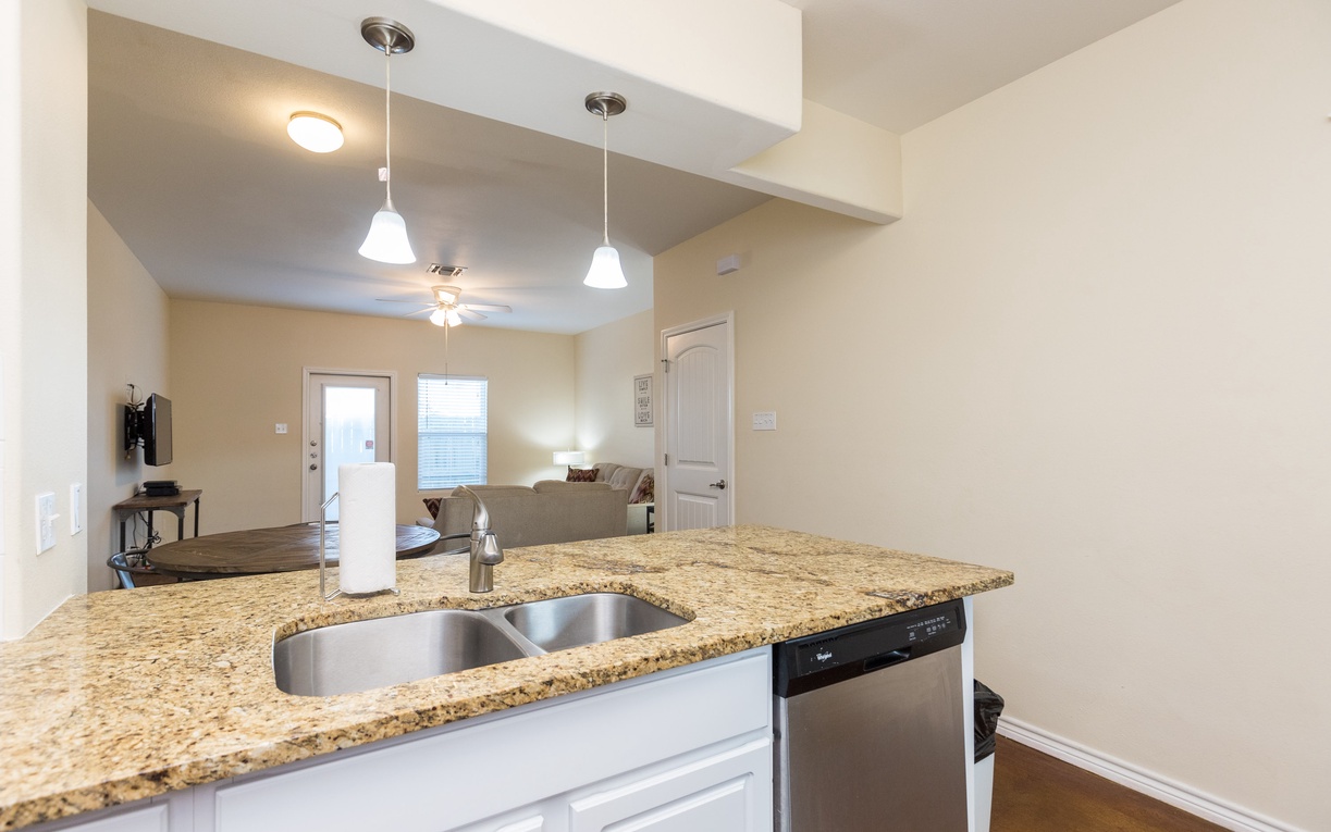 Your open-concept space flows seamlessly from granite kitchen to cozy living room, perfect for relaxing evenings together.