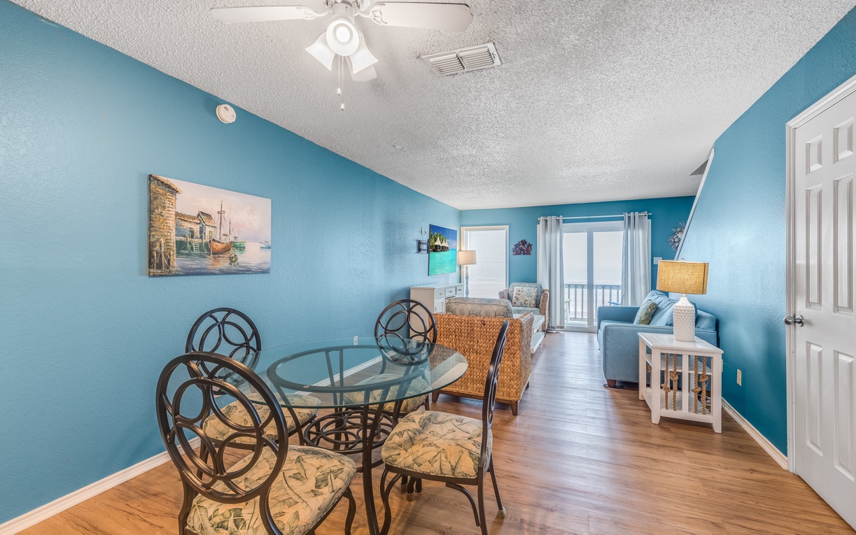 Relax in your bright, beach-themed living space with ocean-inspired blue walls, comfortable seating, and coastal charm throughout.