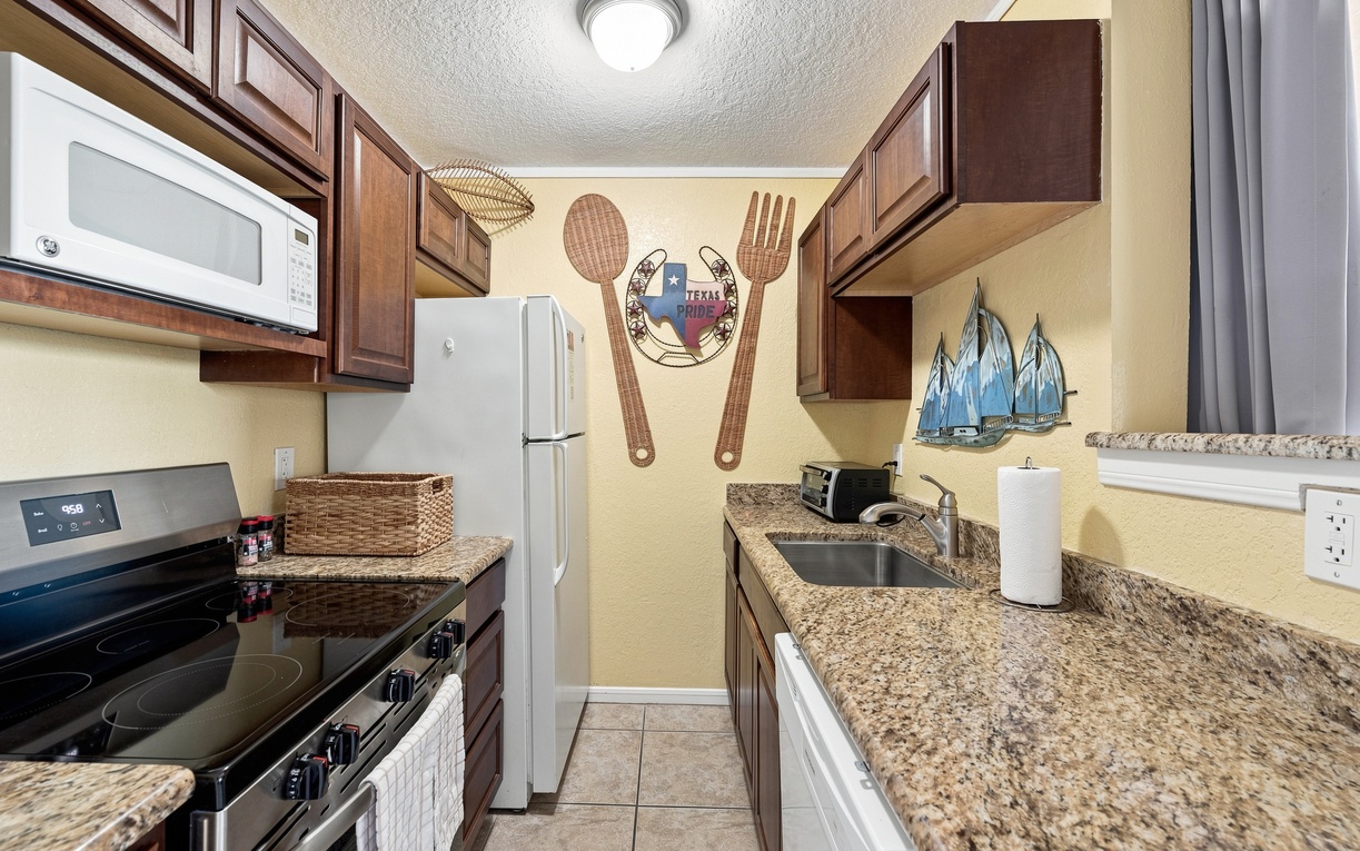 Step into your fully equipped kitchen with granite countertops, modern appliances, and everything you need to whip up your favorite meals during your stay.