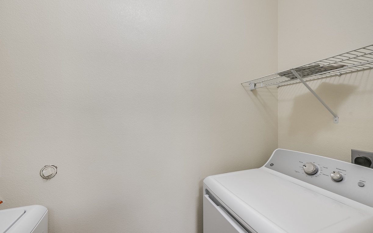 Your laundry needs are covered with a dedicated washing machine and convenient storage shelving for all your essentials.