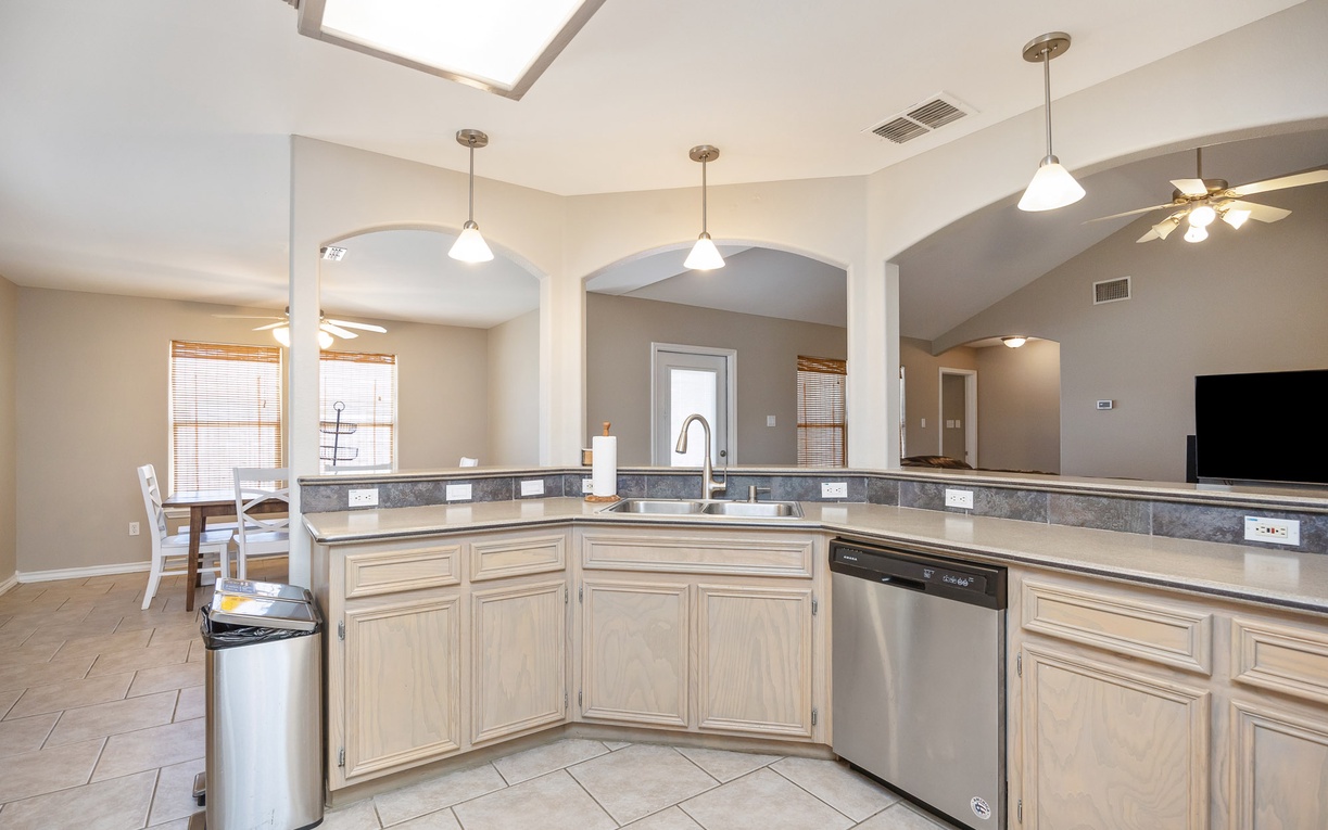 Your spacious kitchen features granite countertops, stainless appliances, and pendant lighting—perfect for preparing memorable vacation meals together.