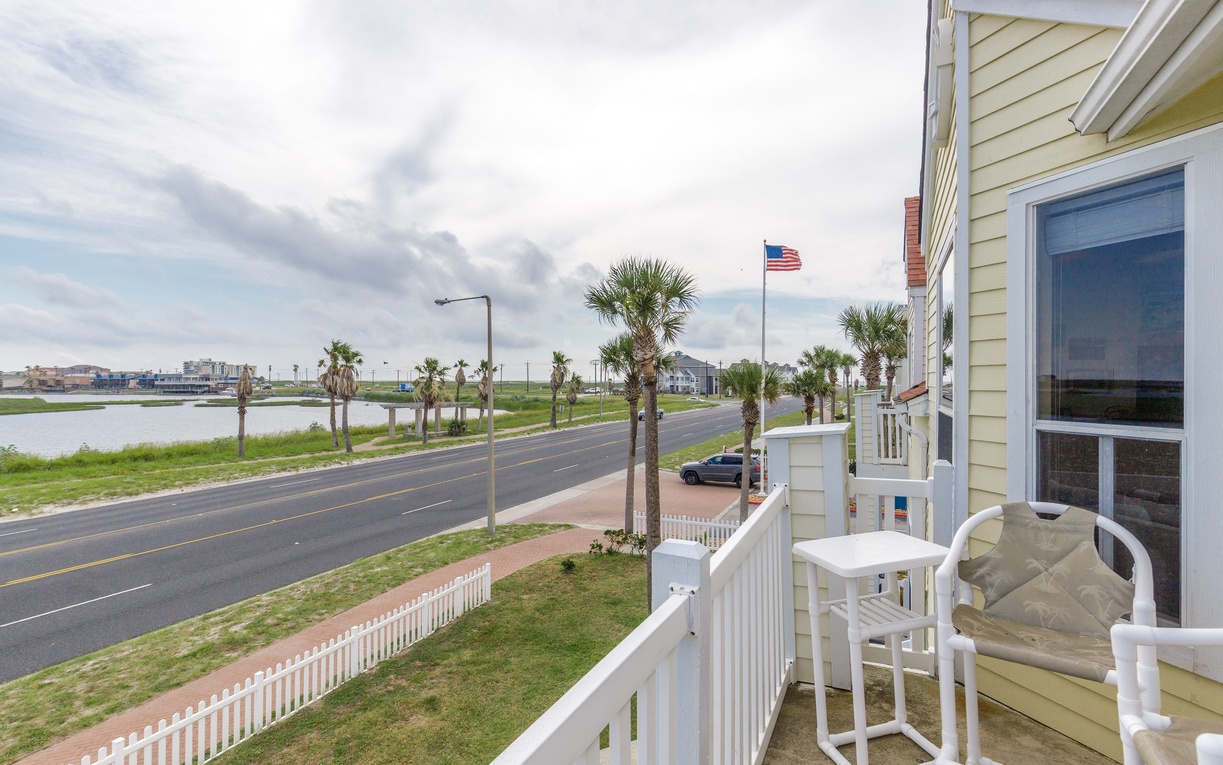 Coastal property featuring palm-lined streets and waterfront views in a peaceful neighborhood setting.