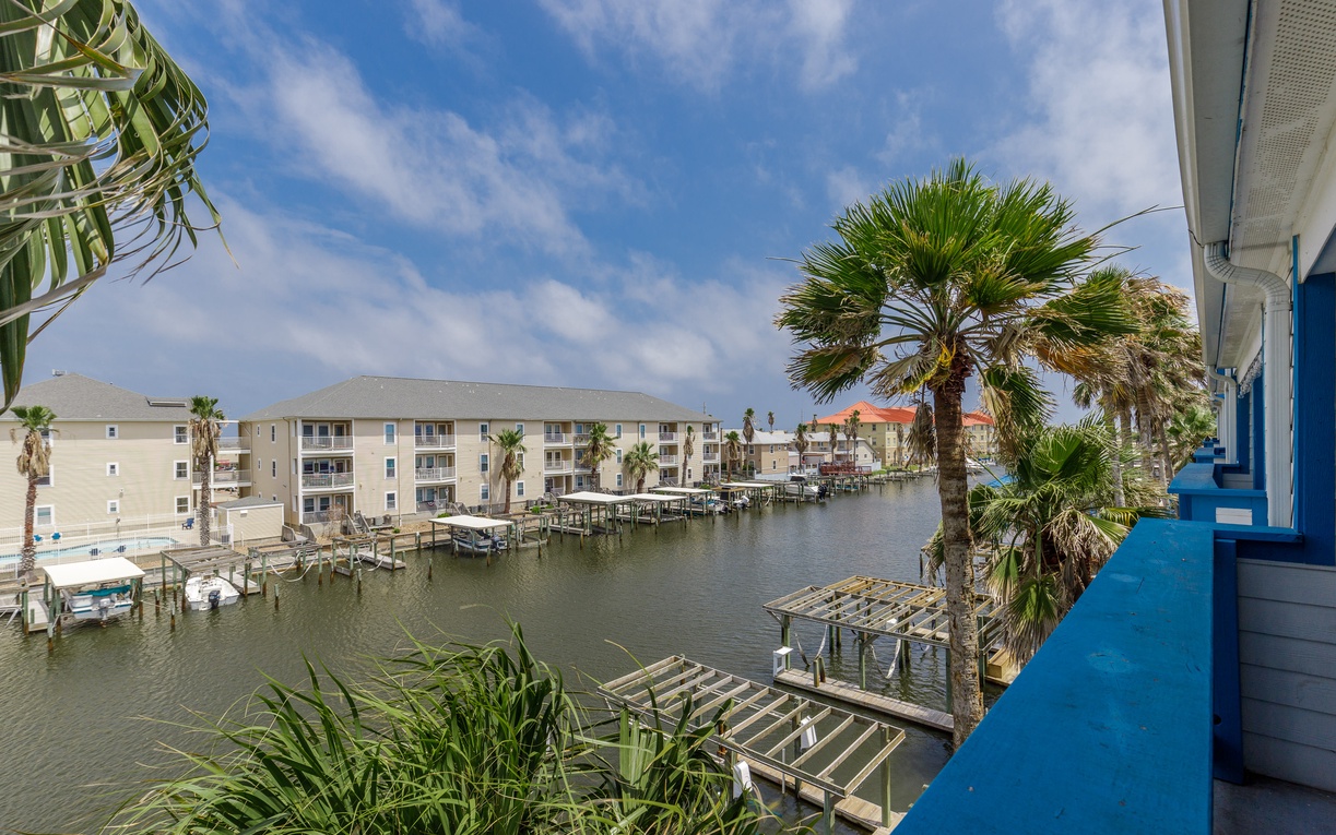 Soak up waterfront views from your private balcony, where palm trees frame the peaceful marina below and coastal charm surrounds you.