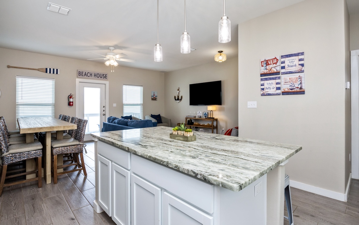 Your modern kitchen island opens to bright living and dining spaces, perfect for gathering while preparing meals or enjoying morning coffee.