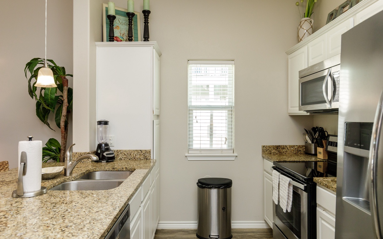 Your fully equipped galley kitchen features granite counters, stainless appliances, and everything you need to prepare meals during your stay.