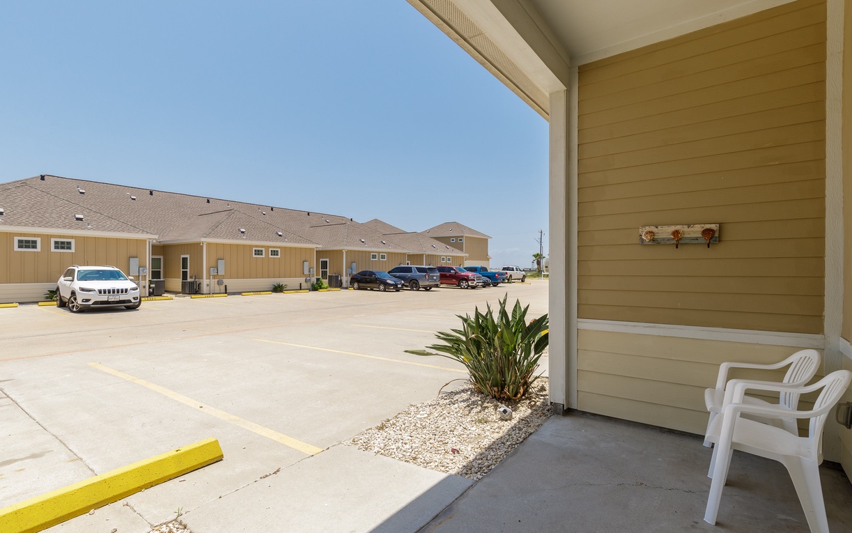 Modern accommodations featuring convenient parking right outside and a covered patio with seating for enjoying the Texas sunshine.