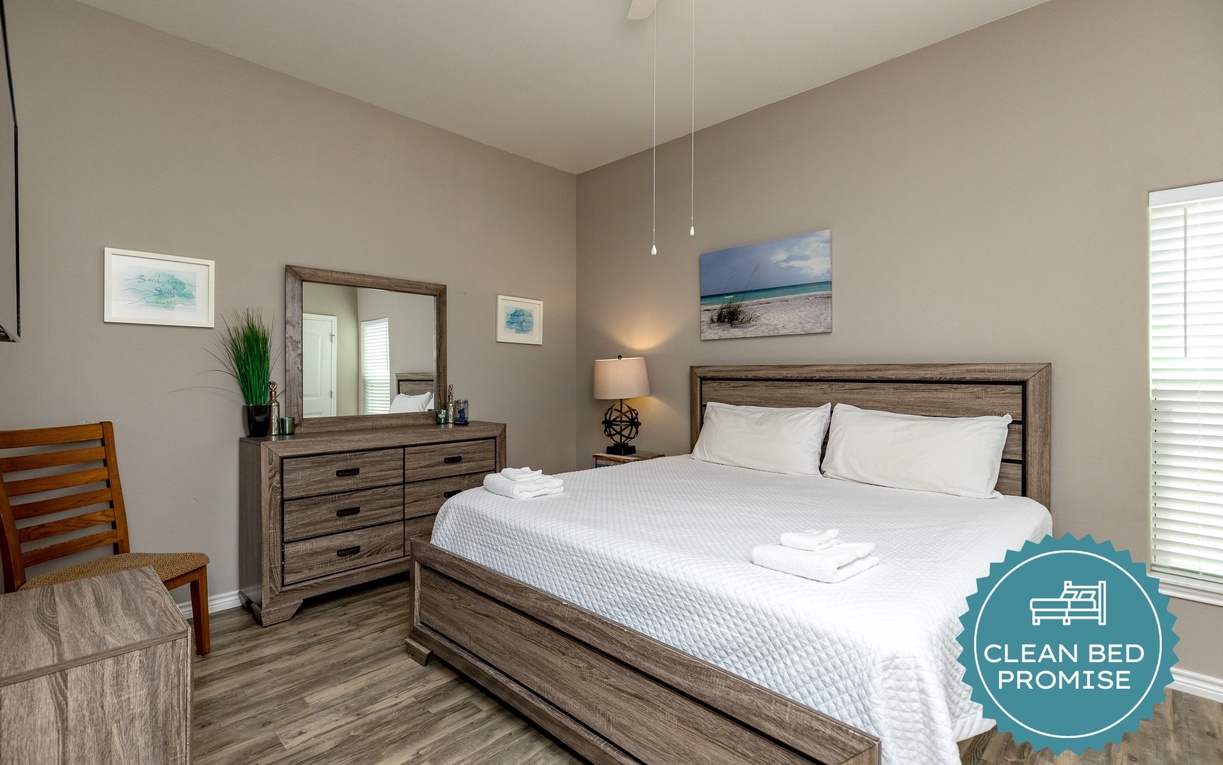 Sink into crisp linens and coastal charm in your beautifully appointed bedroom, complete with modern furnishings and beachy artwork.
