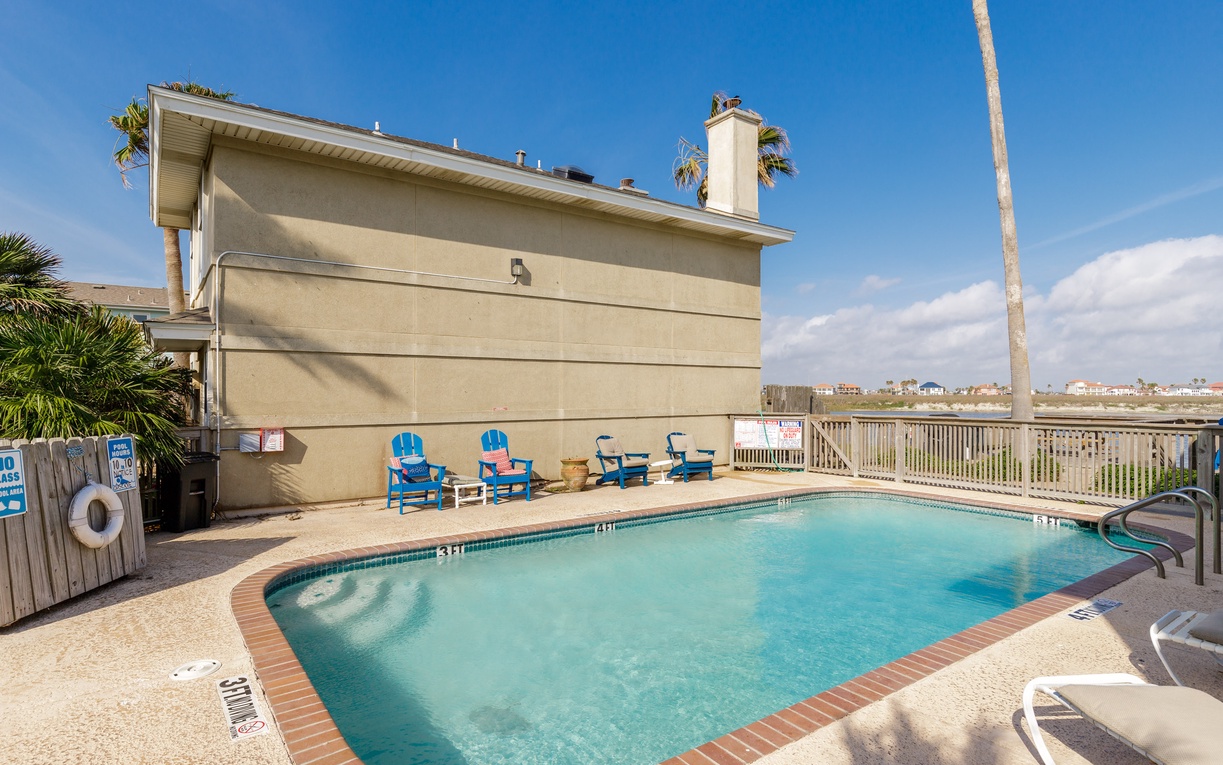 Dive into your private pool paradise with turquoise waters and colorful loungers under endless blue skies.