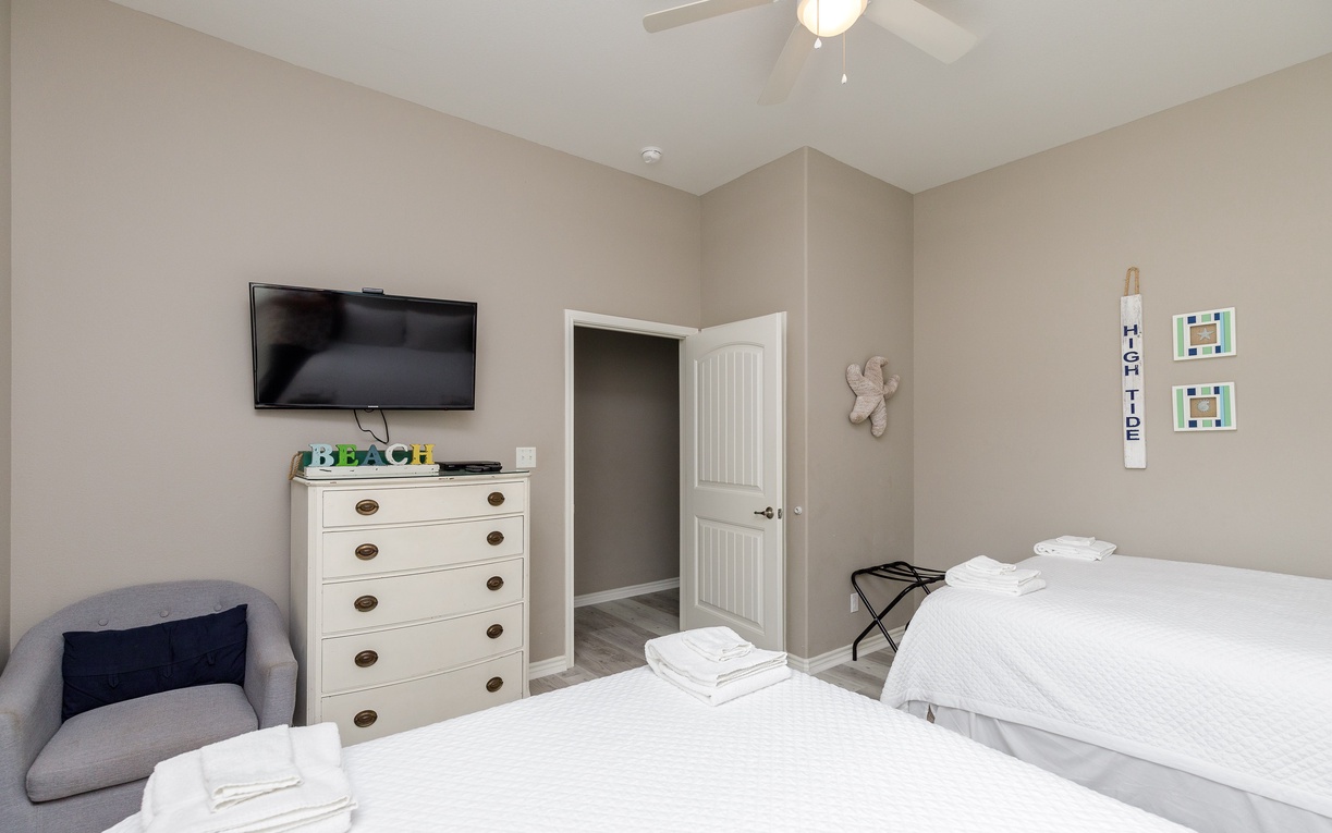 Rest easy in your comfortable bedroom with crisp linens, entertainment options, and thoughtful touches for a perfect night's sleep.
