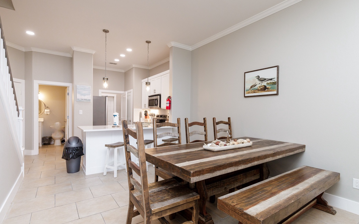 Gather around your rustic dining table where shared meals become treasured memories in this welcoming open-plan space.